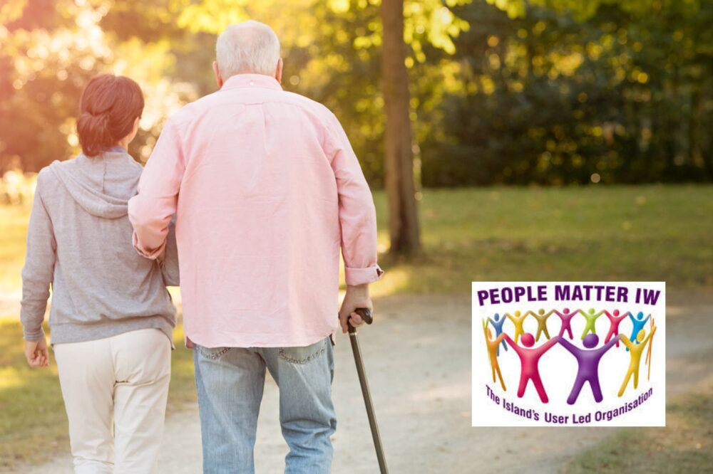 People Matter IW Pair of adults walking in a path, one with a walking stick